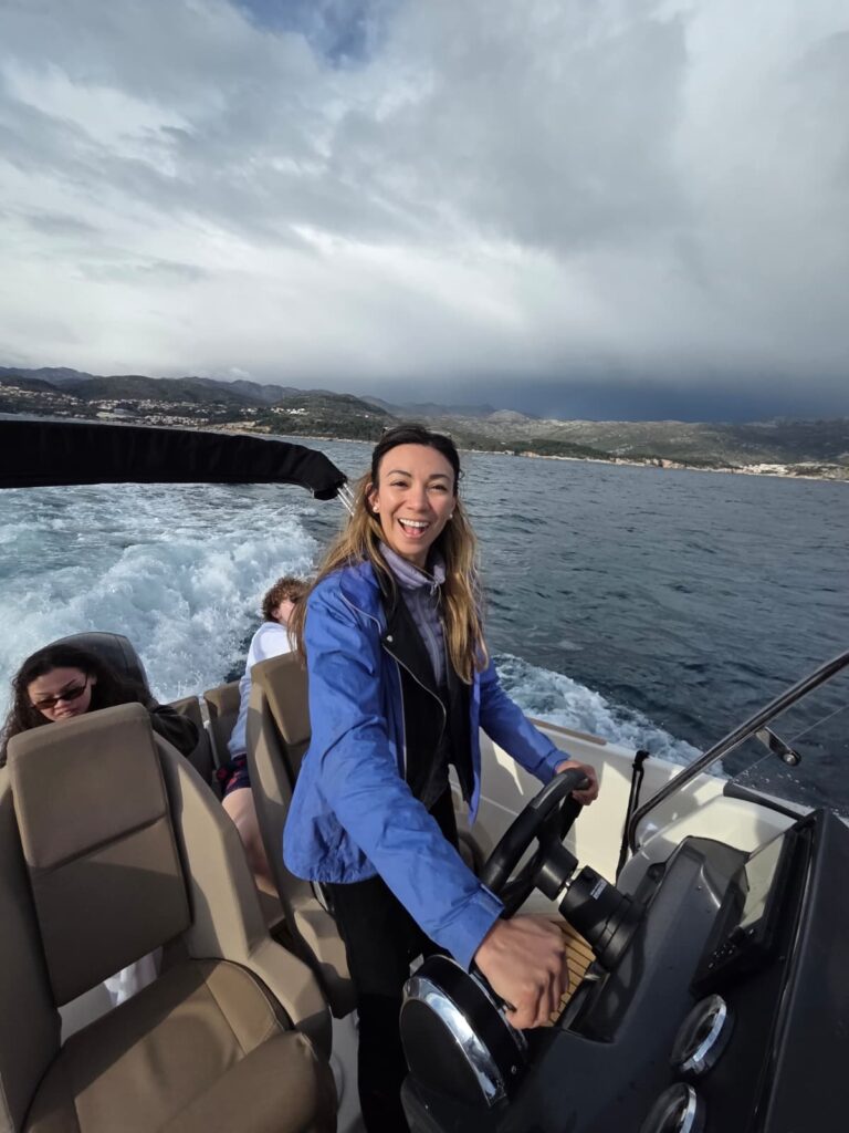 woman driving speedboat in Dubrovnik Adriatic sea self drive boat rental experience Croatia coastline